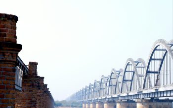 Wallpaper A Large Bridge Spanning Over a Large Body of Water