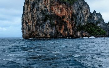 Wallpaper A Large Rock in the Middle of the Ocean