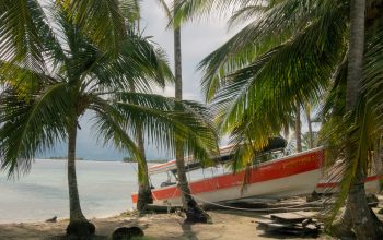 Wallpaper A Red and White Boat on a Beach