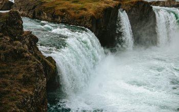 Wallpaper A River with a Waterfall in the Middle