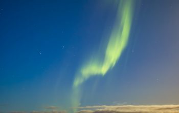 Wallpaper A Green and Yellow Aurora Borealis in the Sky