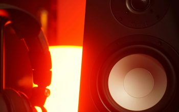 Wallpaper A Pair of Headphones Beside a Speaker