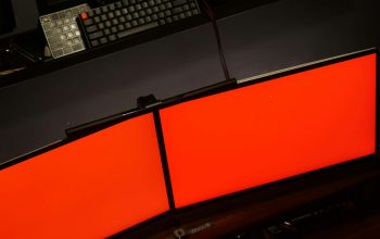 Wallpaper A Computer Desk with Two Monitors and Keyboard