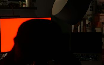 Wallpaper A Person Sitting in Front of a Computer Monitor