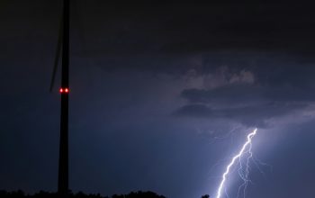 Wallpaper A Lightning Bolt Hitting Through a Dark Sky