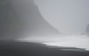 Wallpaper A Ball Sitting on the Beach in the Fog