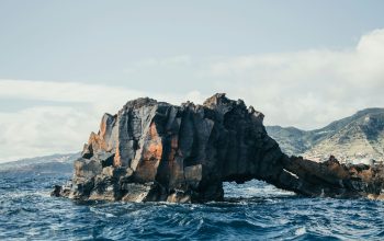 Wallpaper A Rock in the Middle of the Ocean