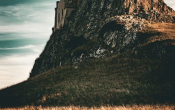 Wallpaper A Castle Perched Atop a Rocky Cliff