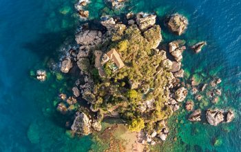 Wallpaper An Island Surrounded by Turquoise Waters