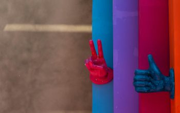 Wallpaper Colorful Hand Sculptures Emerge from Vertical Panels