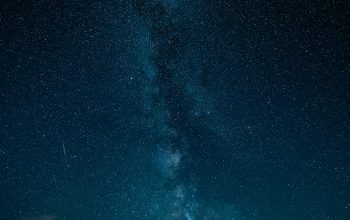 Wallpaper Milky Way Shines Brightly Over Dark Mountains
